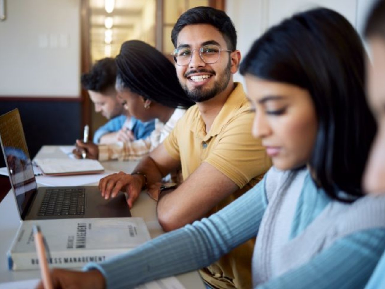 education-university-students-lecture-studying-learning-business-management-scholarship-college-portrait-happy-man-with-laptop-books-group-friends-modern-classroom