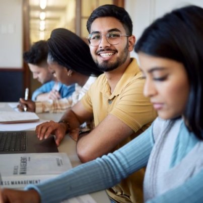 education-university-students-lecture-studying-learning-business-management-scholarship-college-portrait-happy-man-with-laptop-books-group-friends-modern-classroom