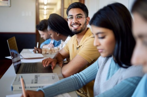 education-university-students-lecture-studying-learning-business-management-scholarship-college-portrait-happy-man-with-laptop-books-group-friends-modern-classroom